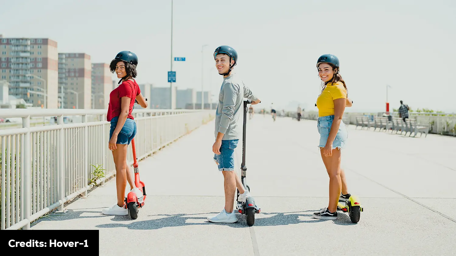 Three people riding scooters in a city. Scooter Advice