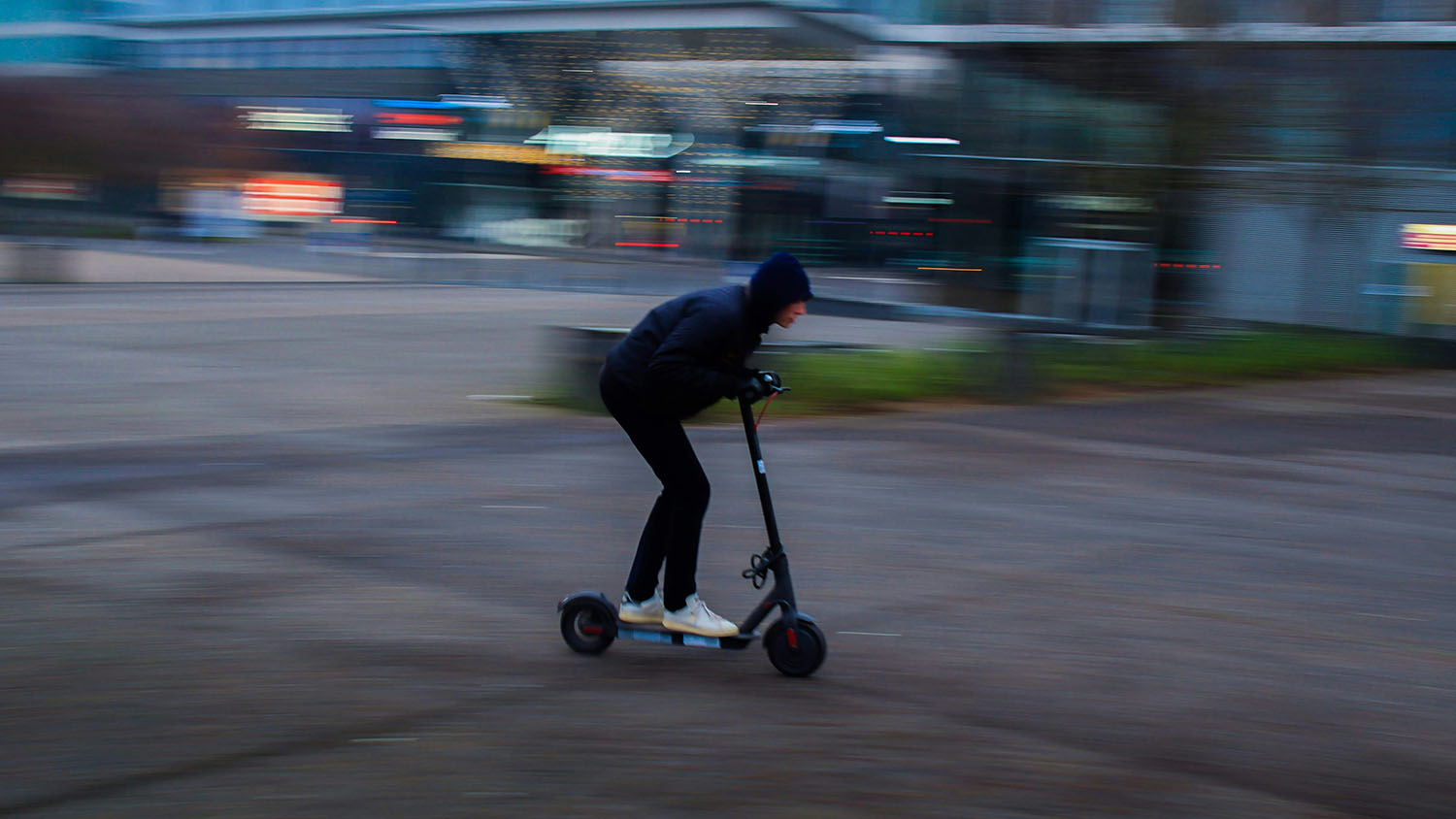A person efficiently cruising on a lime scooter through a bustling city. Scooter Advice