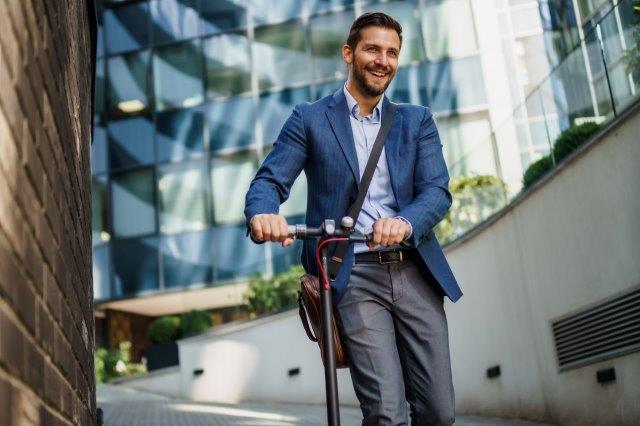 A man riding a scooter. Scooter Advice 360