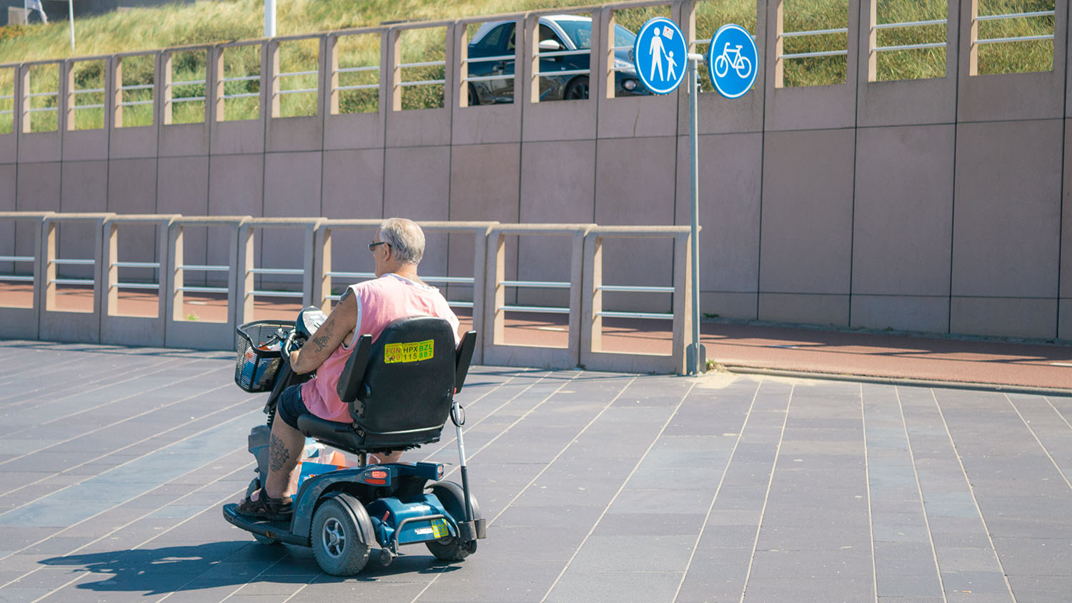 A man in a wheelchair on a sidewalk. Scooter Advice
