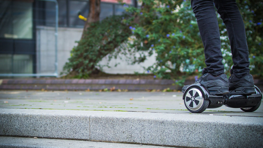 A person riding a hoverboard on steps. Scooter Advice