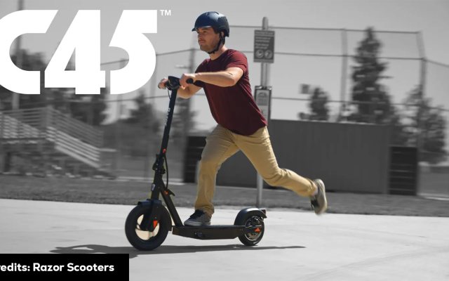 A man riding an electric scooter at high speed. Scooter Advice