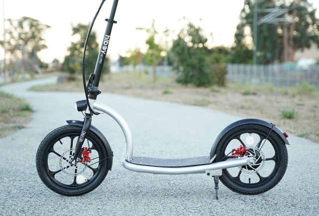 A black and white scooter is parked on a street. Scooter Advice